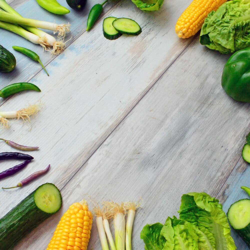 Green vegetables lined up in a circle on a table