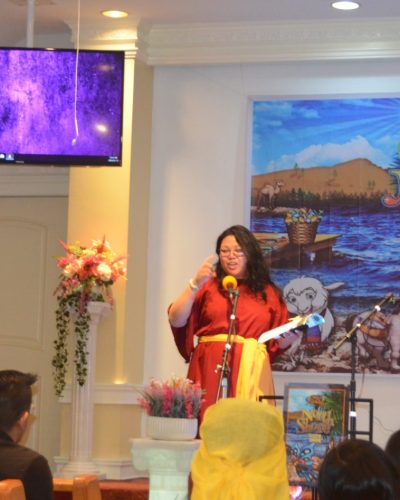 Woman giving a message during children's ministry