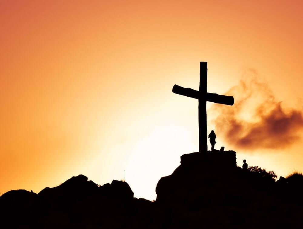 Cross on a hill during a sunset