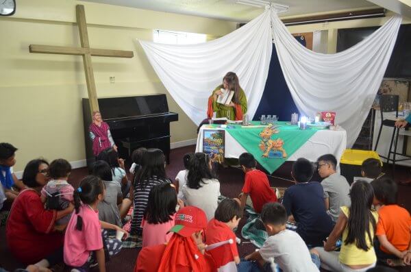 Reading a Bible story to children during Vacation Bible School