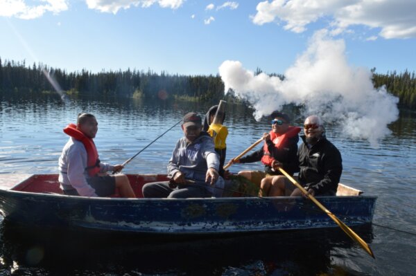 Men's outing on a boat fishing on a lake