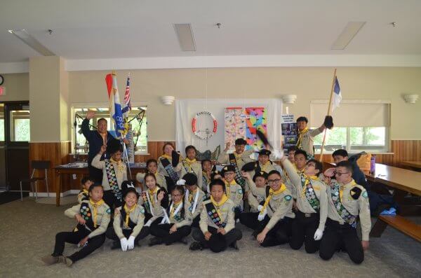 Pathfinders posing for a group photo in front of their booth