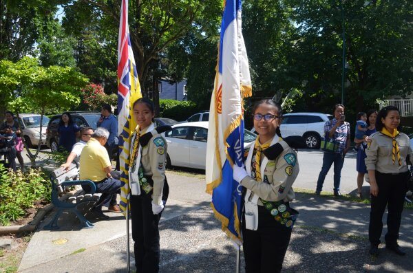 Two Pathfinder girls holding up flags