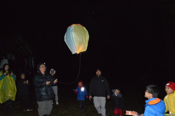 Pathfinders fly a lantern at night time during the Cultus Lake mini camporee