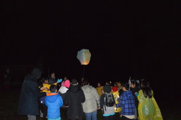 Pathfinders fly a lantern at night time during the Cultus Lake mini camporee