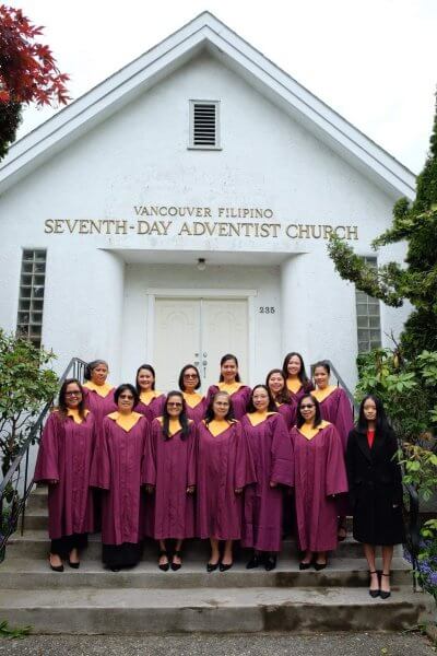 Women's choir standing all together for a photo outside the VanFil Church