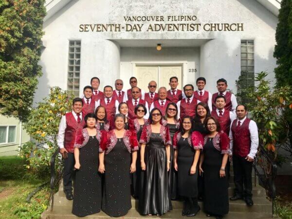 Choir team standing all together for a photo outside the VanFil building