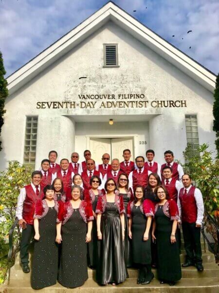 Choir team standing all together for a photo outside the VanFil building