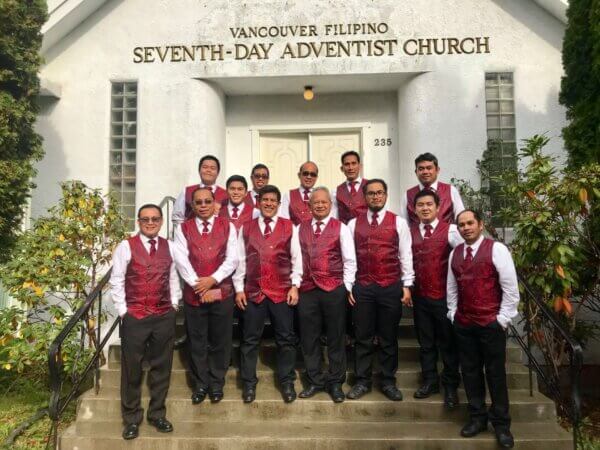 Choir team standing all together for a photo outside the VanFil building