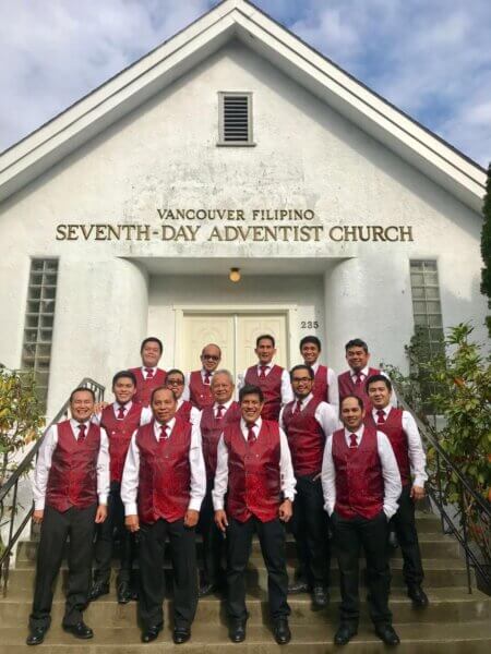 Choir team standing all together for a photo outside the VanFil building